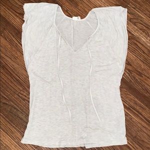 Very loose blouse, cream colored.
